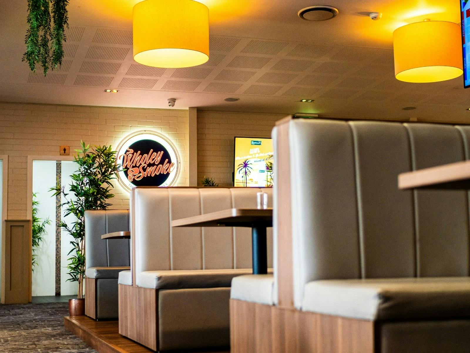 seating area of Wholey Smoke Bistro with booth seating