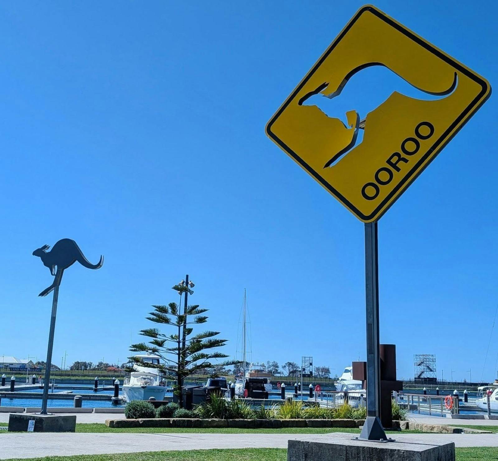 Sculpture of a kangaroo on a pole and a kangaroo sign imprinted yellow