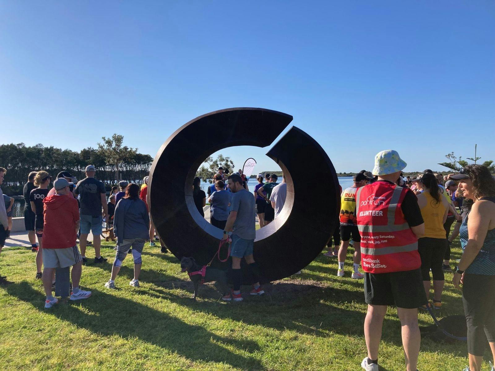 Group of people ready for the park run around a sculpture
