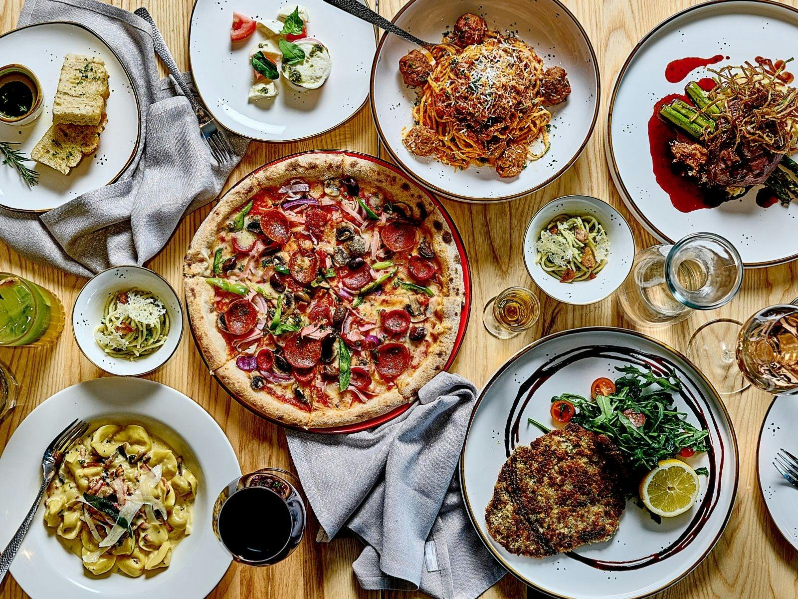 Pizza and pastas plated on table
