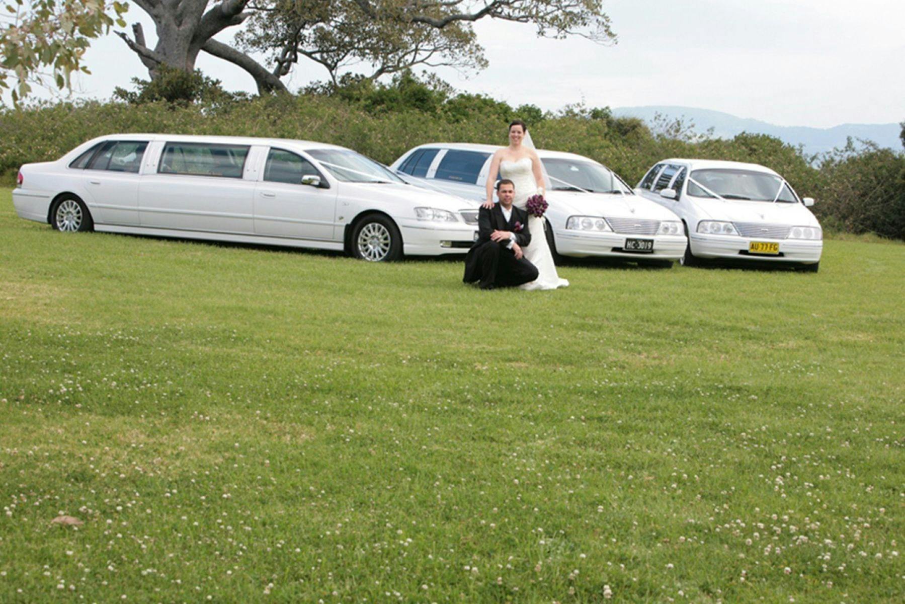 Three White Wedding Cars - Limosenes,  with bride and groom