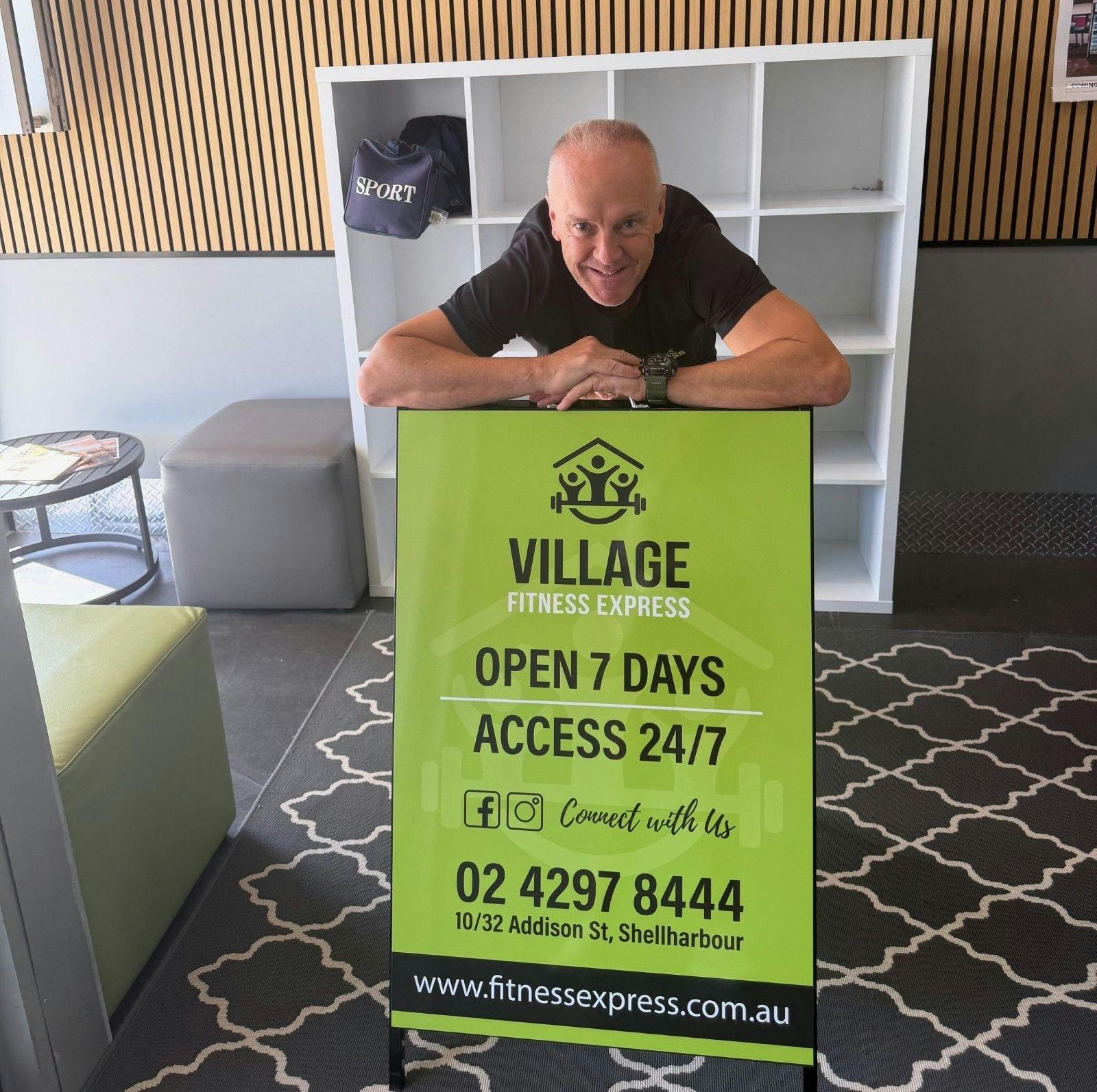 Mark Leatham (owner) in reception area with new sandwich board signage