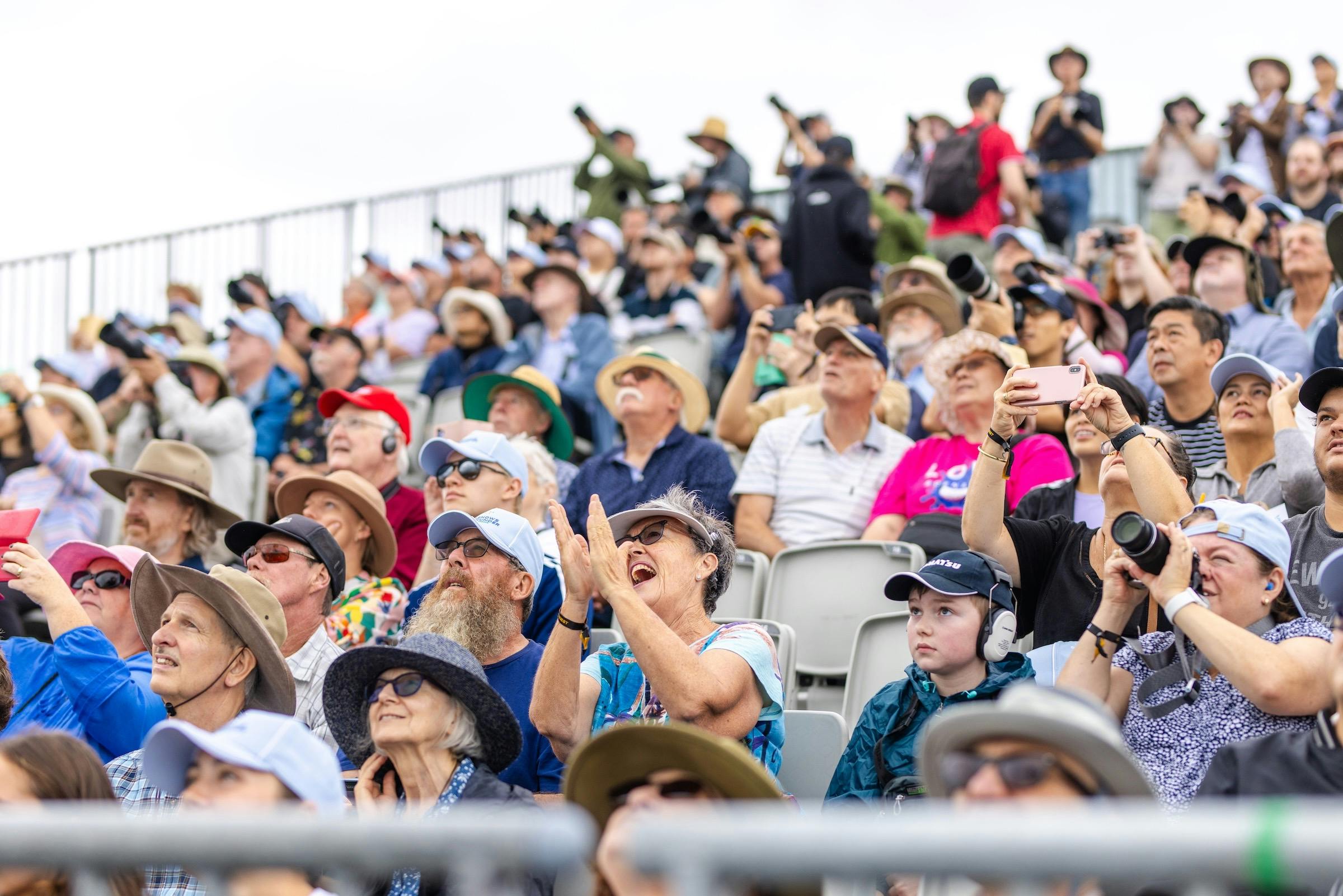 The crowd enjoying the airshow from the grandstand seating