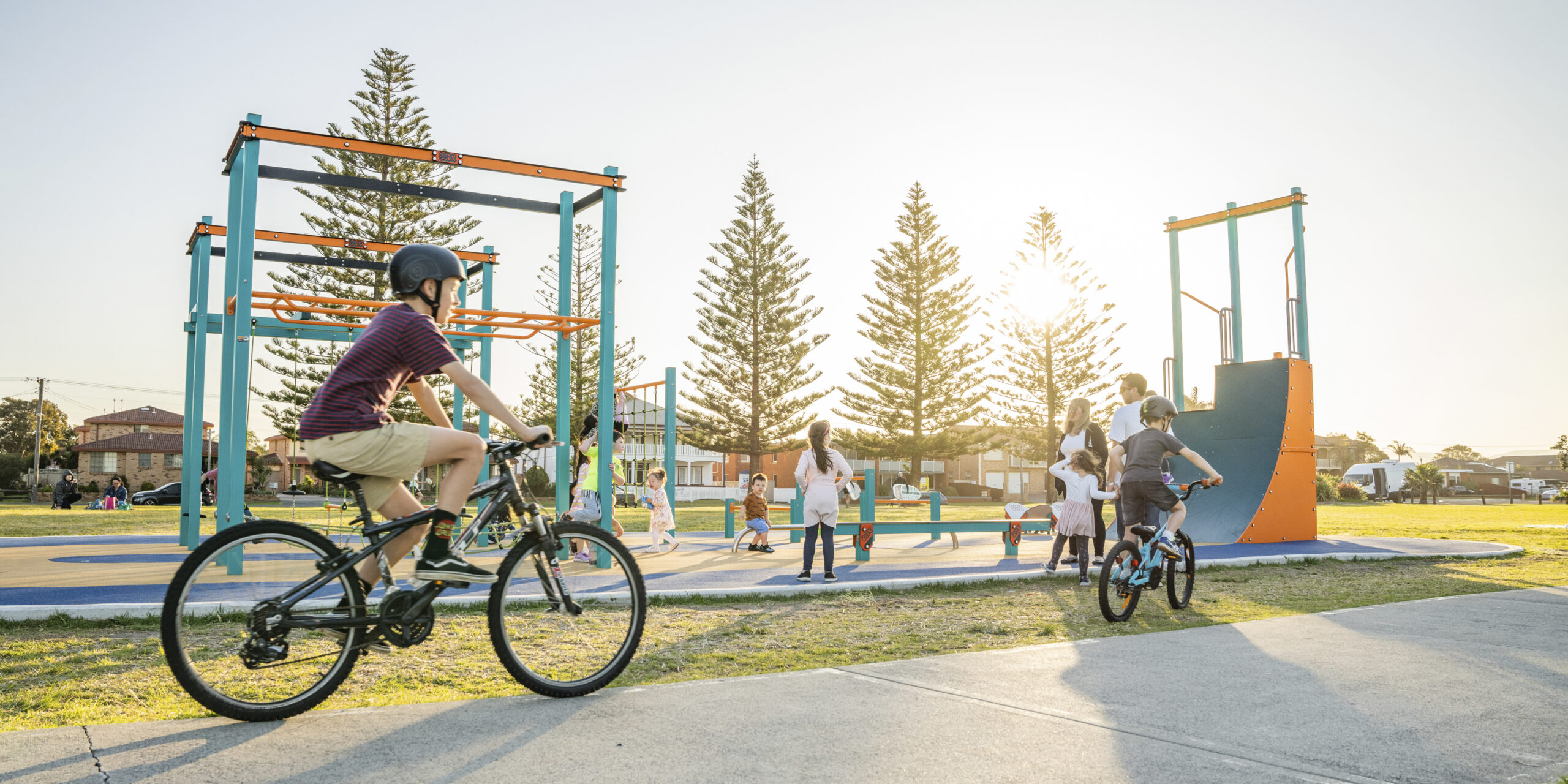 Child cycling past a Ninja Park Playground along th shared pathway along Lake Illawarra