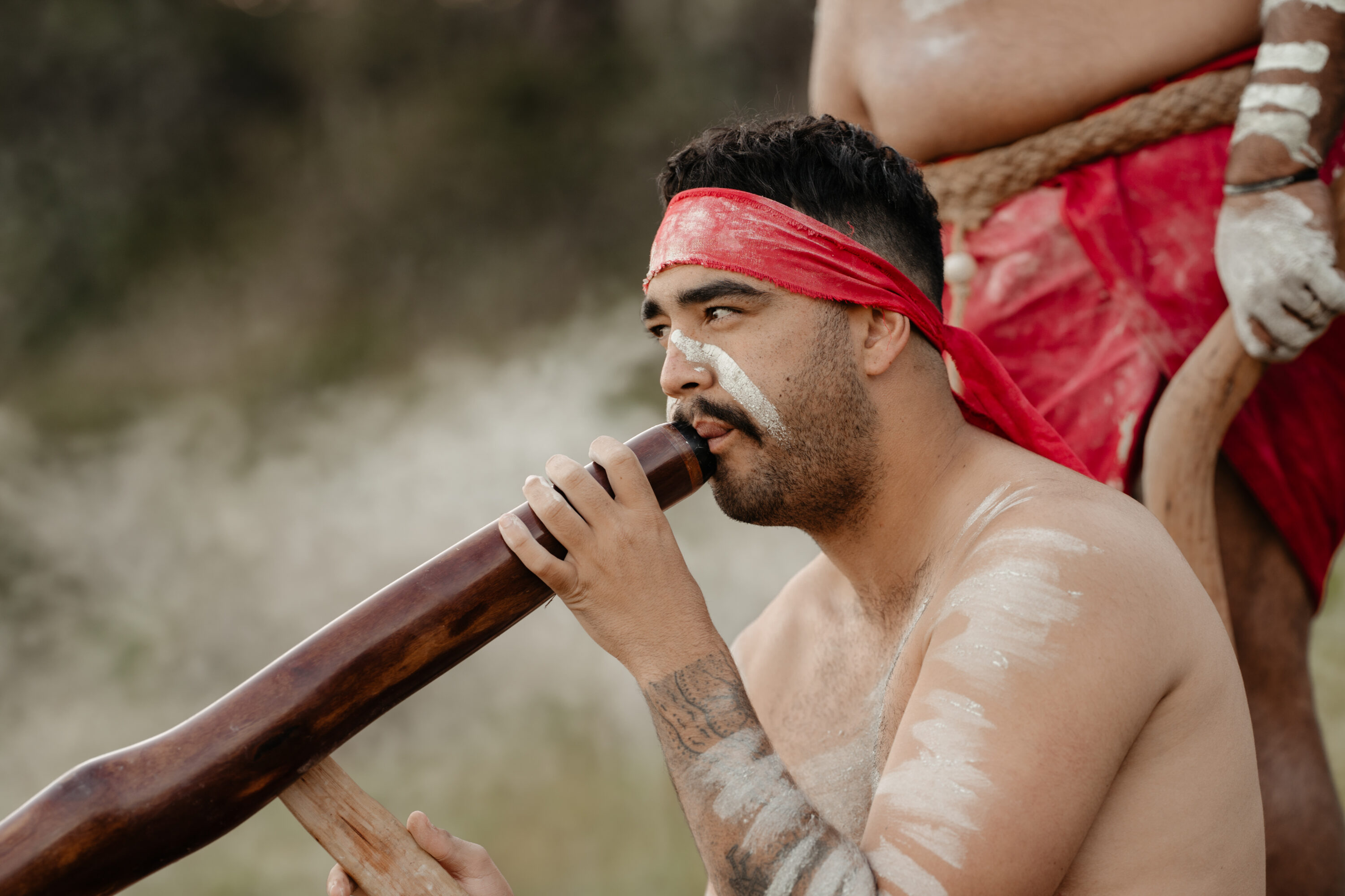 Person playing a didgeridoo