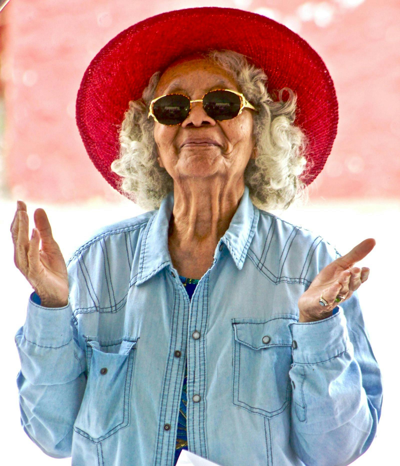 Female Senior wearing red hat and sunglassess