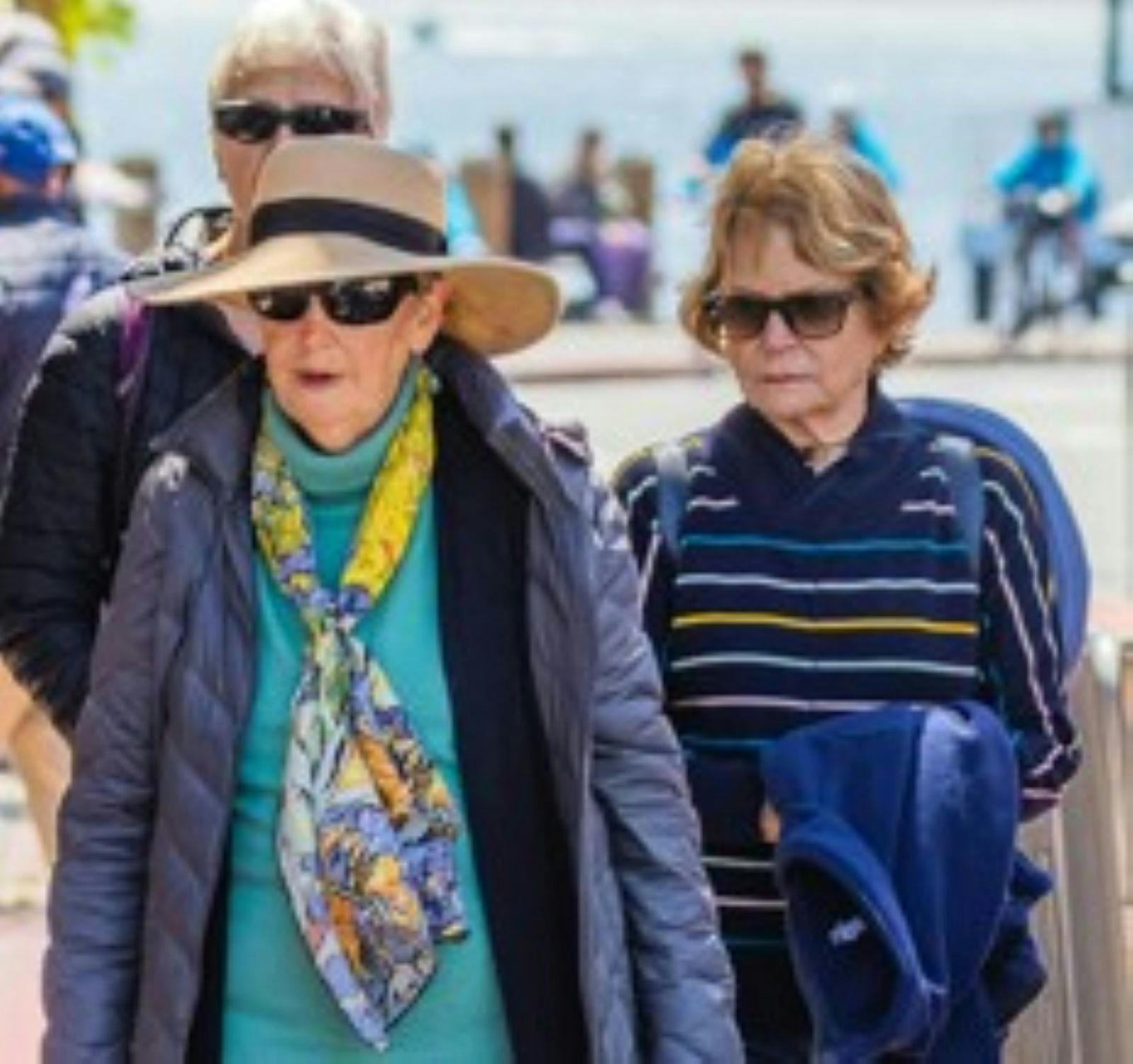 Group of 3 seniors walking on a tour