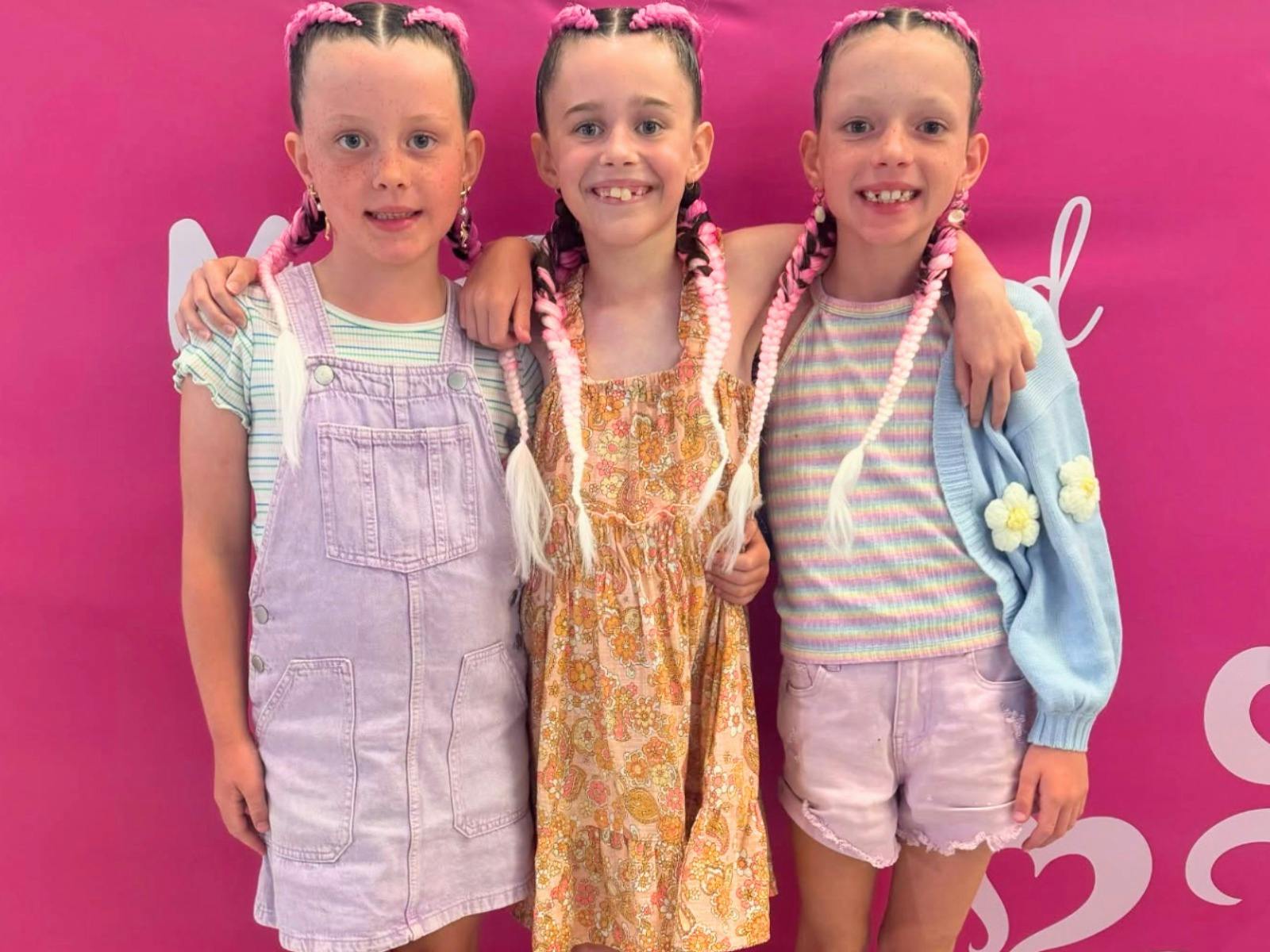 3 Girls all with hair braided standing together