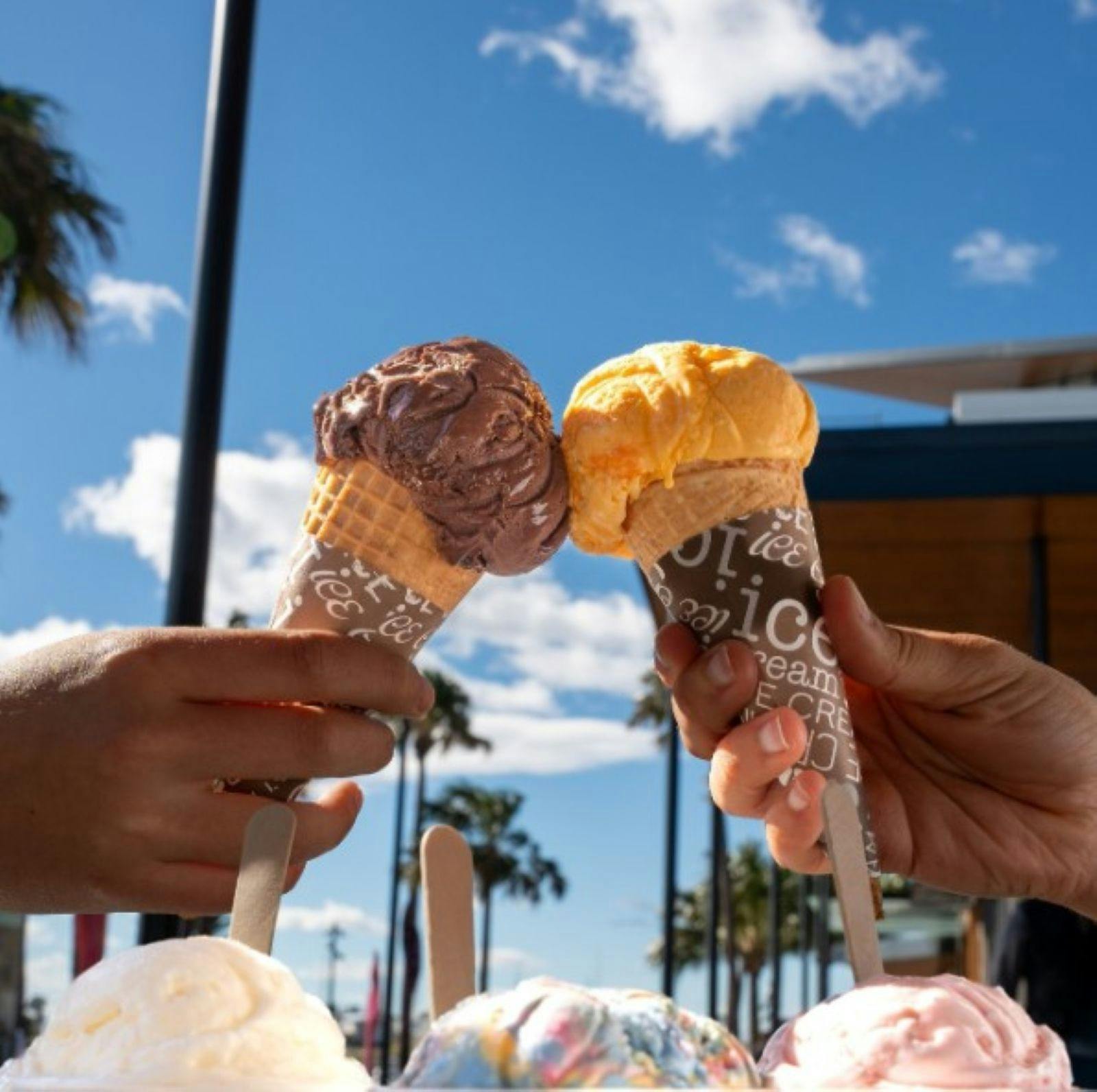 hands holding iceream cones