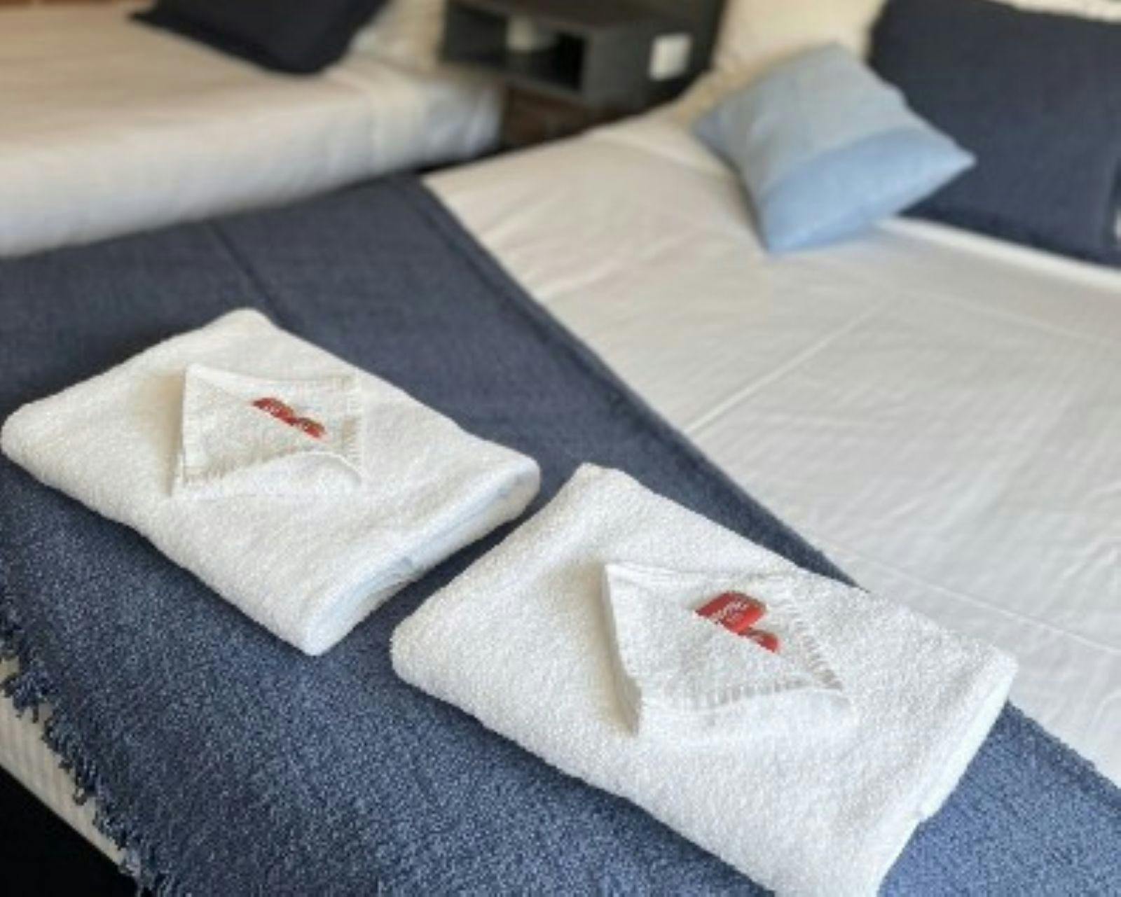 Motel Bed made up with towels on display