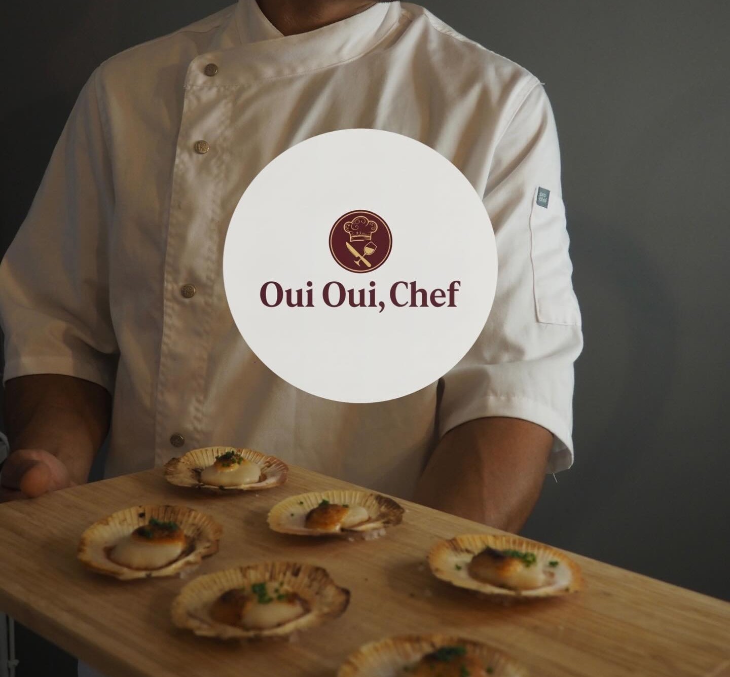 Chef holding board of scallops
