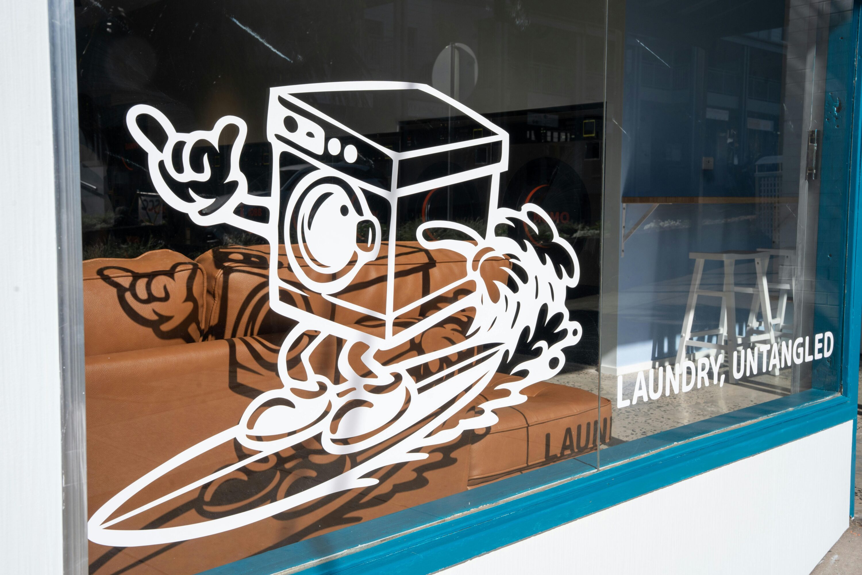Drawing on the window of a cartoon washing machine on a surfboard